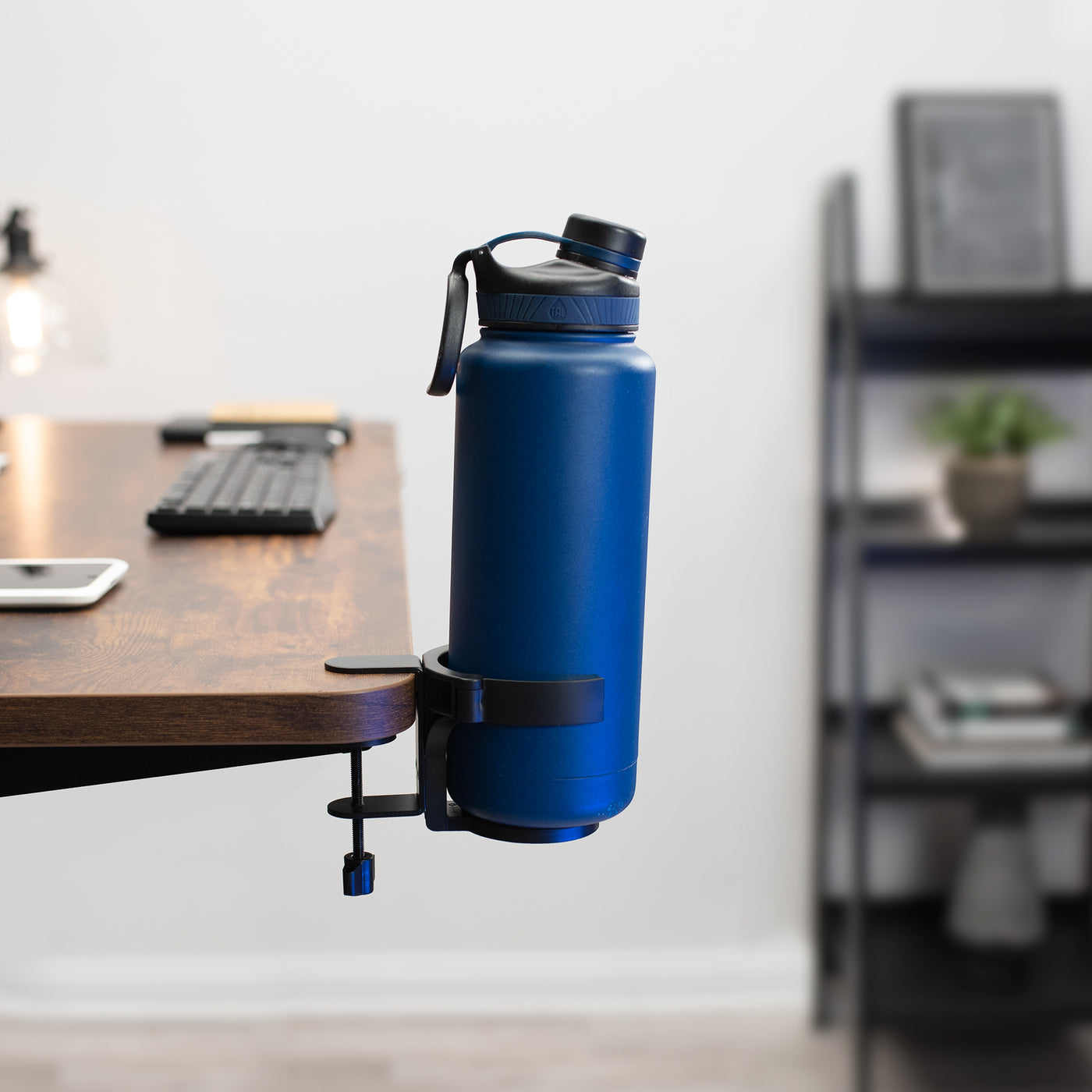 Water bottle desk mount for a designated spot off of the self for your water bottle.