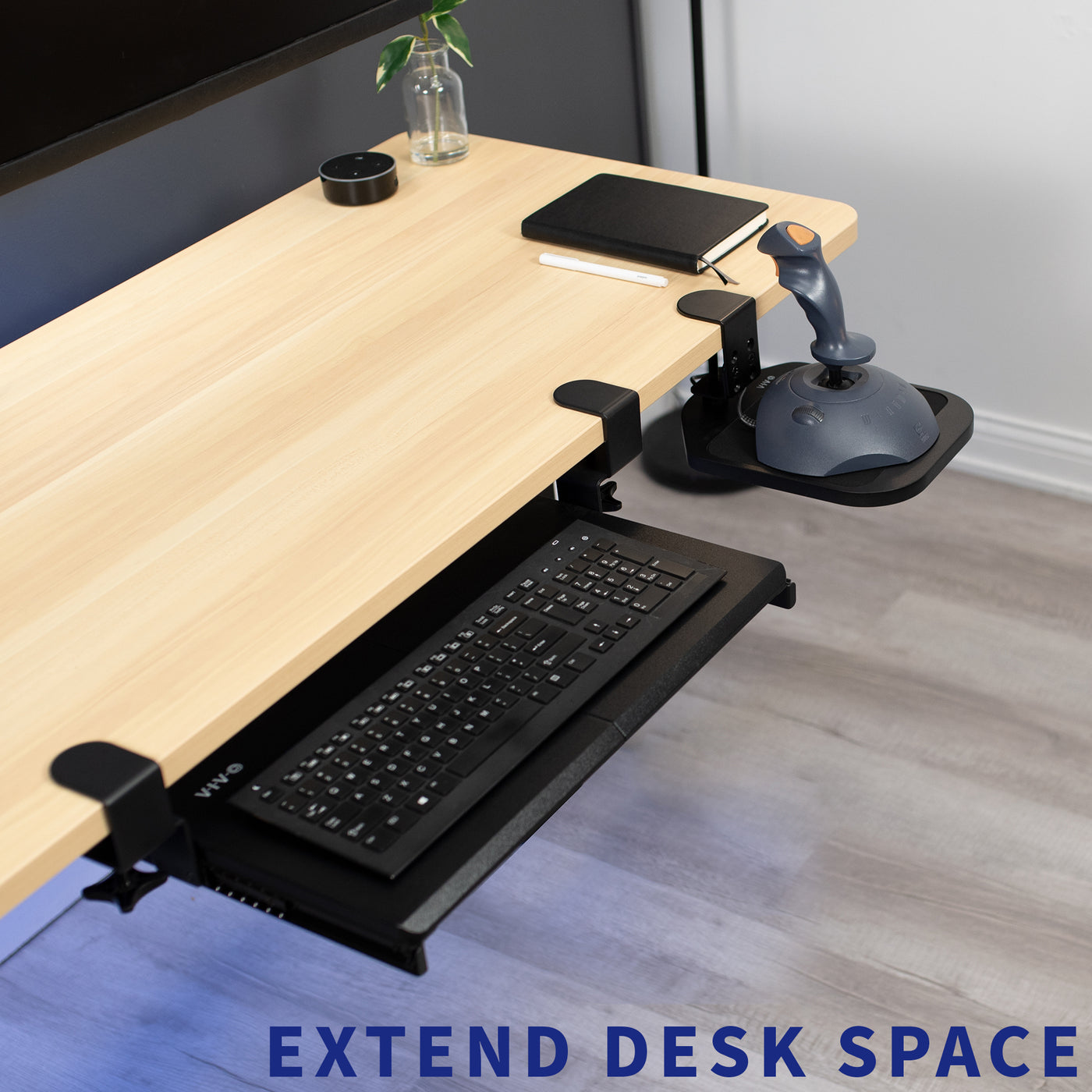 Under desk keyboard tray with an additional mouse tray holding a remote controller.
