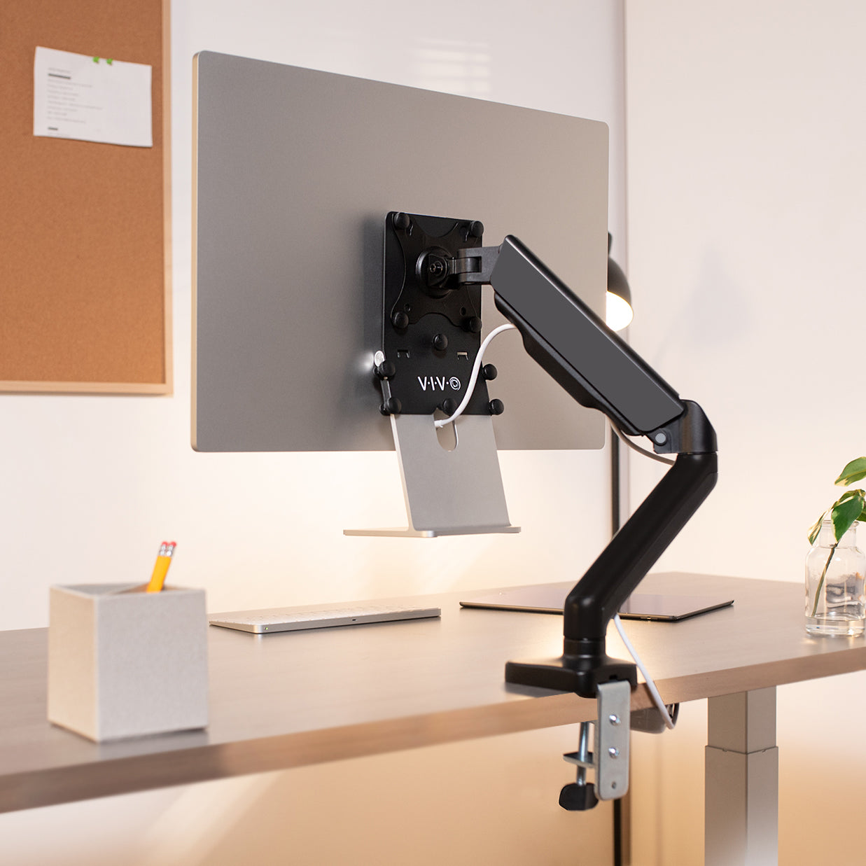  A MAC with an adjustable bracket to attach to a clamp on the desk mount.