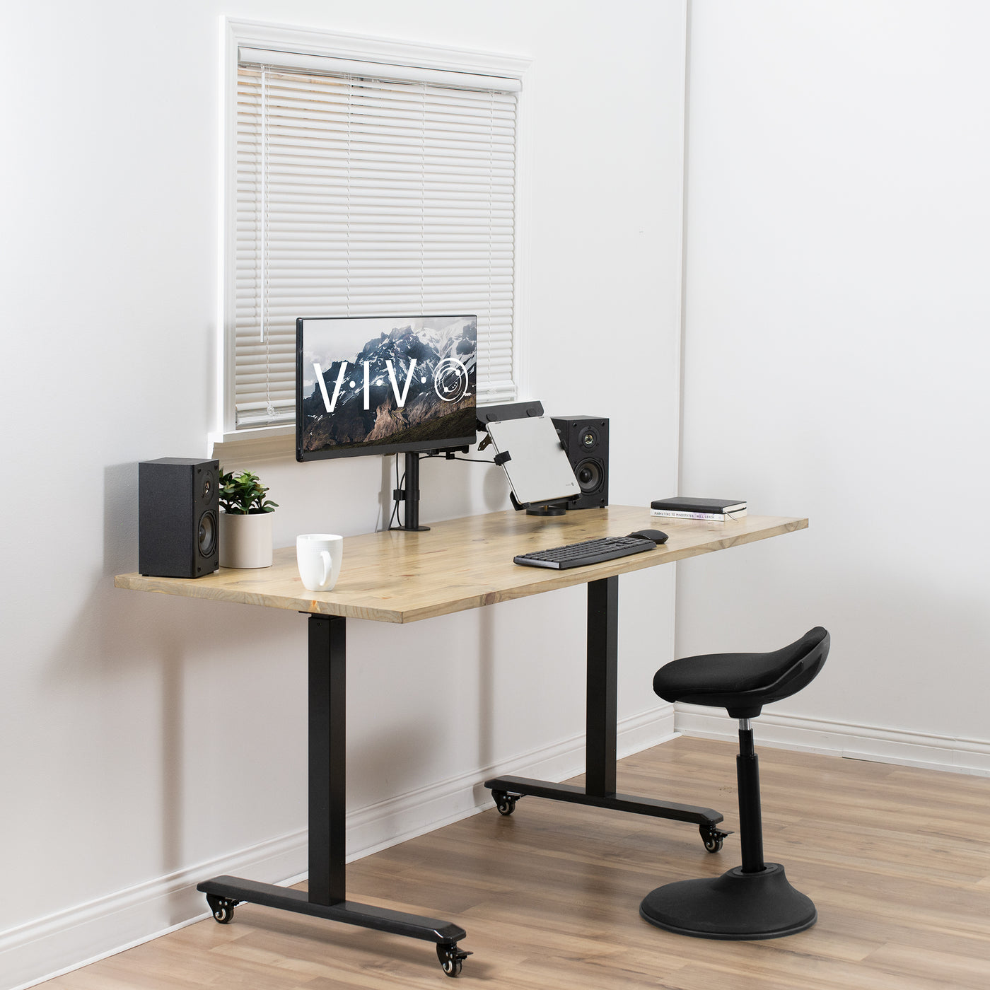 Live office space with an adjustable laptop stand arm.