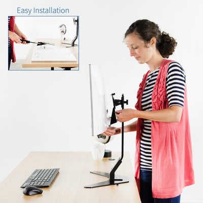 A person attaching a Samsung monitor to a VESA bracket and monitor mount.