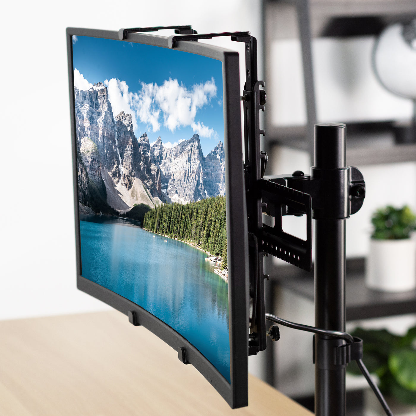 Universal mounting bracket supporting a larger monitor to a  desk mount.