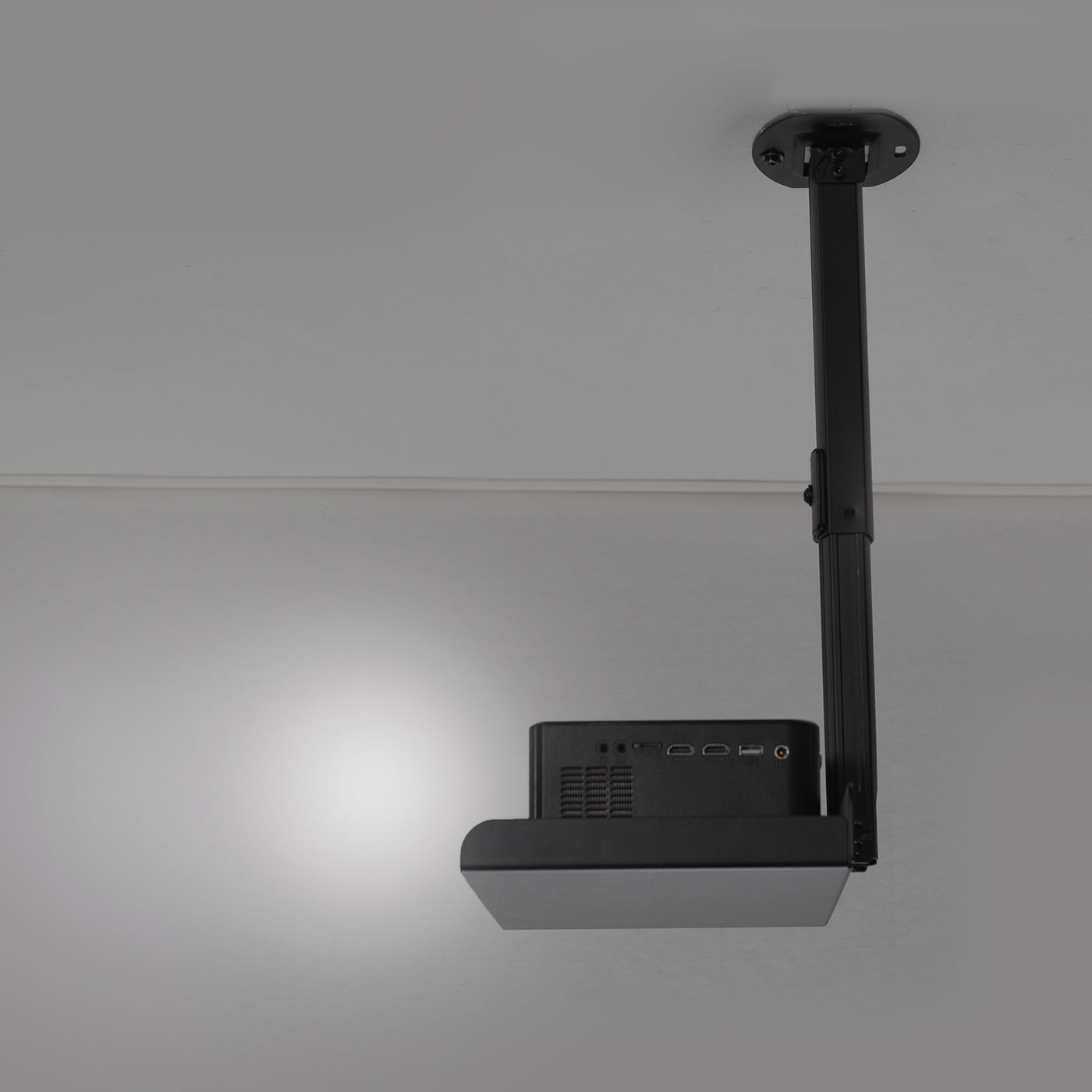 Ceiling shelf mount pole supporting a projector.