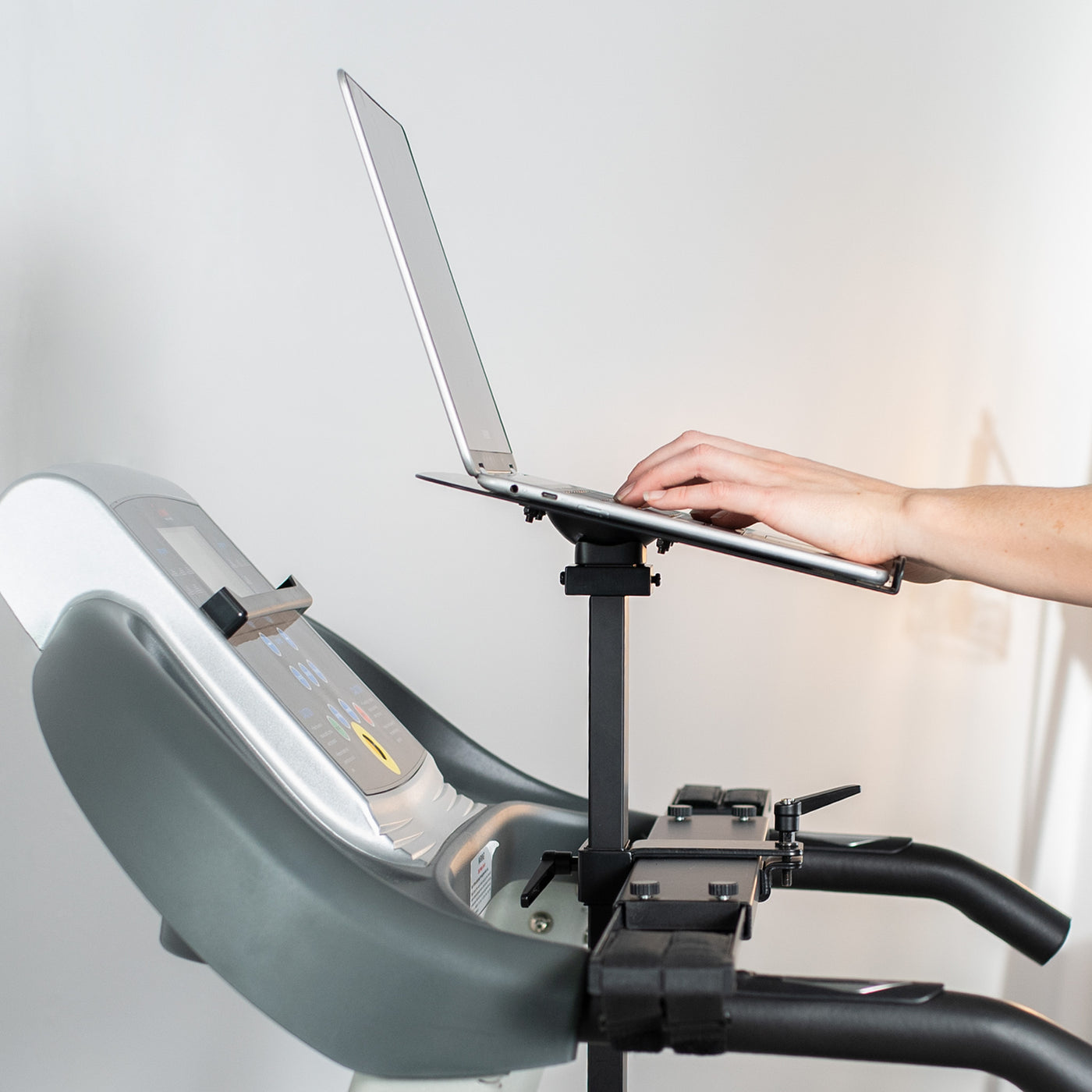 Sturdy height-adjustable laptop tray attachment for treadmills.