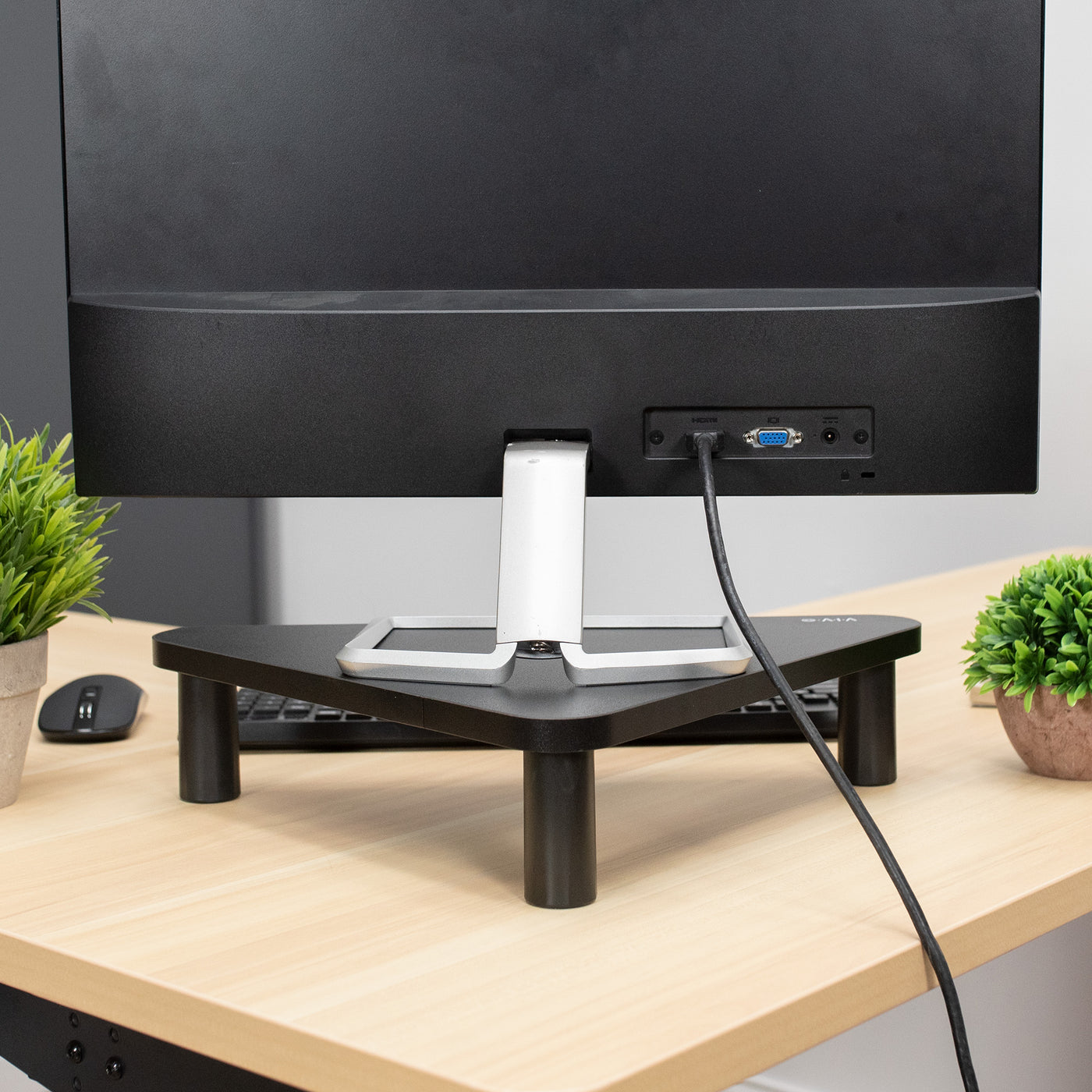 Sturdy corner tabletop monitor riser for comfortable viewing.