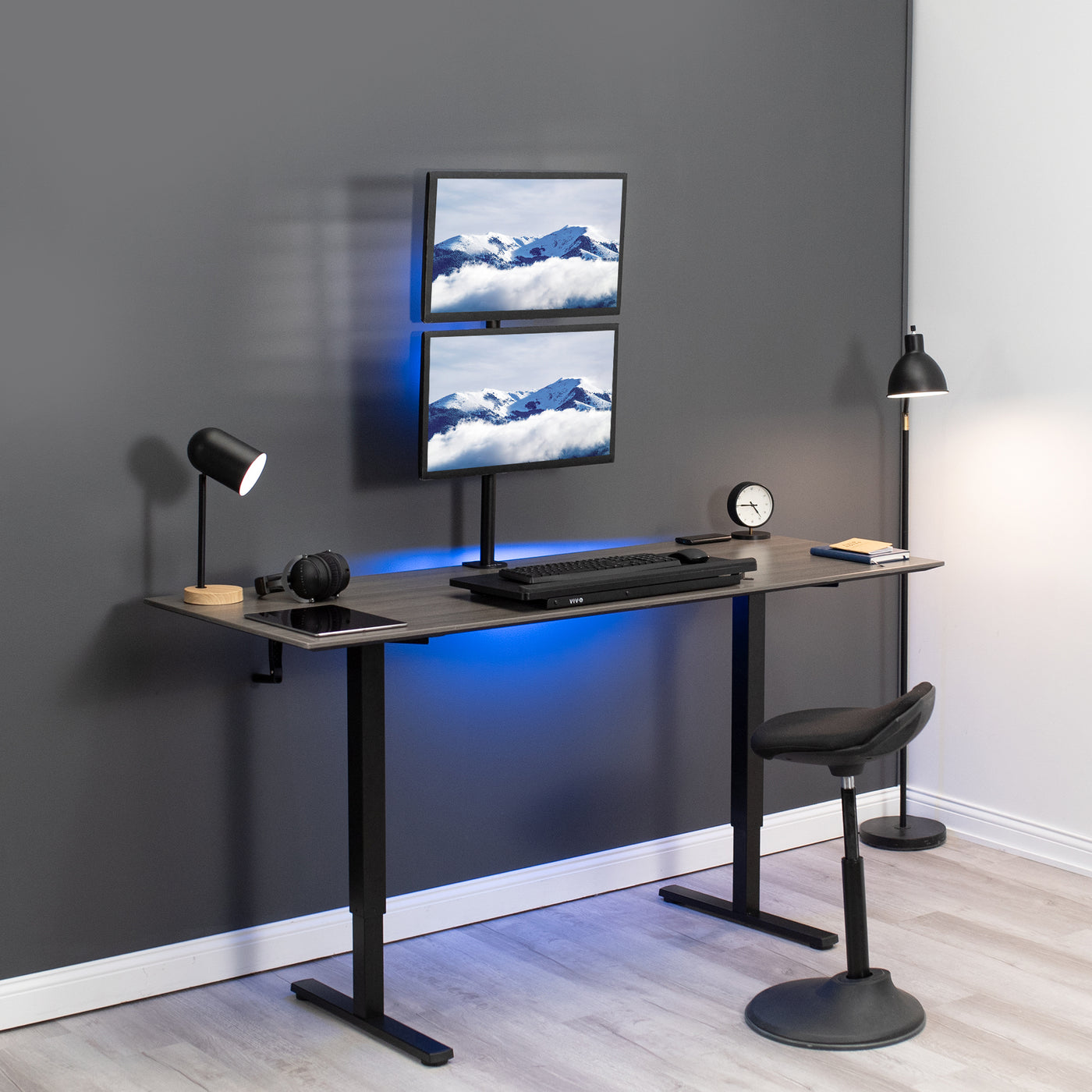 Sturdy adjustable vertical dual monitor ergonomic desk mount for office workstation.