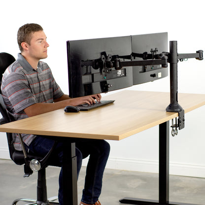 man sitting at Dual Monitor Desk Mount