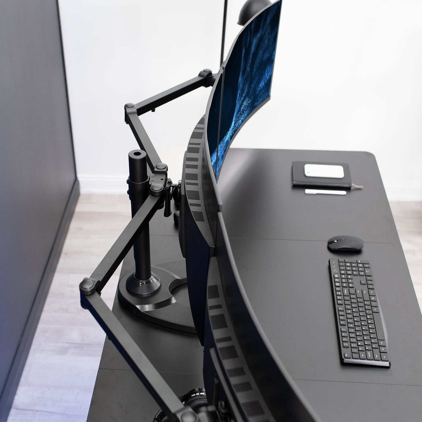 Sturdy height adjustable triple monitor desk stand.